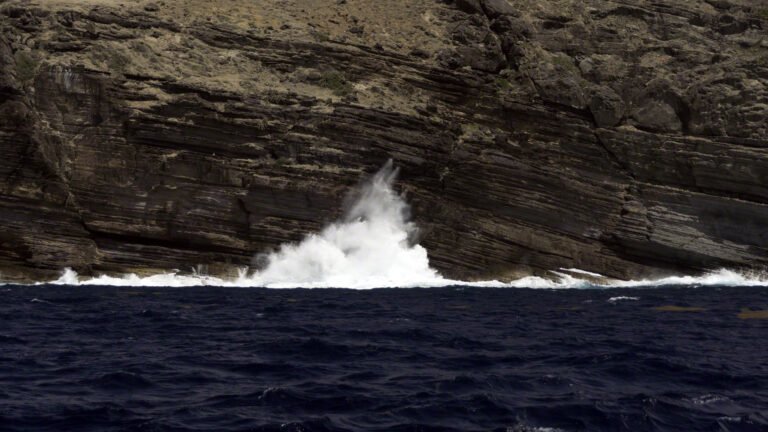 Waves crashing against the cliffs