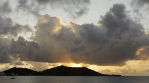 The sun setting around the point at Grand Case