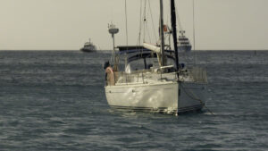 Two boats come in through the channel to the North Sound as sunset approaches