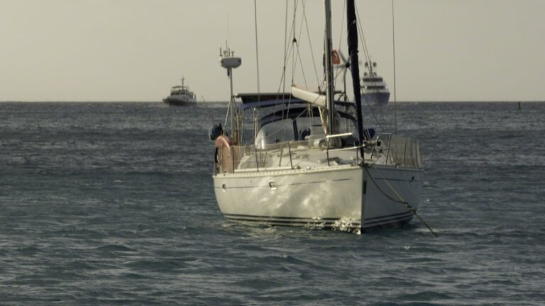 Two boats come in through the channel to the North Sound as sunset approaches