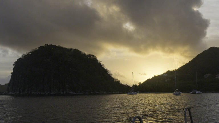 The sun is rising between the Sugarload and main island at 06:30 in the morning