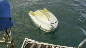 The strong and gusty winds had managed to turn the dinghy over at night, and getting it right-side-up with the engine still attached was a bigger effort than I'd thought.