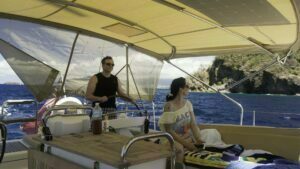 Sascha at the helm of Zanshin while navigating the Iles des Saintes passage