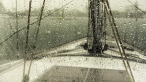 Raindrops washed the outside of the dodger clean of the collected salt of recent travels