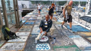 Spray-painting Cyrilla on the dock